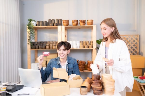 A young couple runs a small business. making clay ornaments Providing payment services by credit card